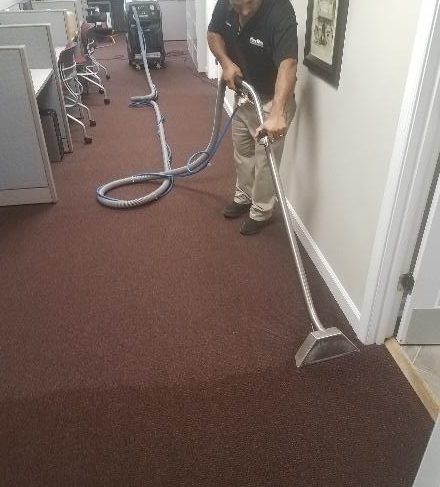 Mister Kleen employee cleaning a carpet